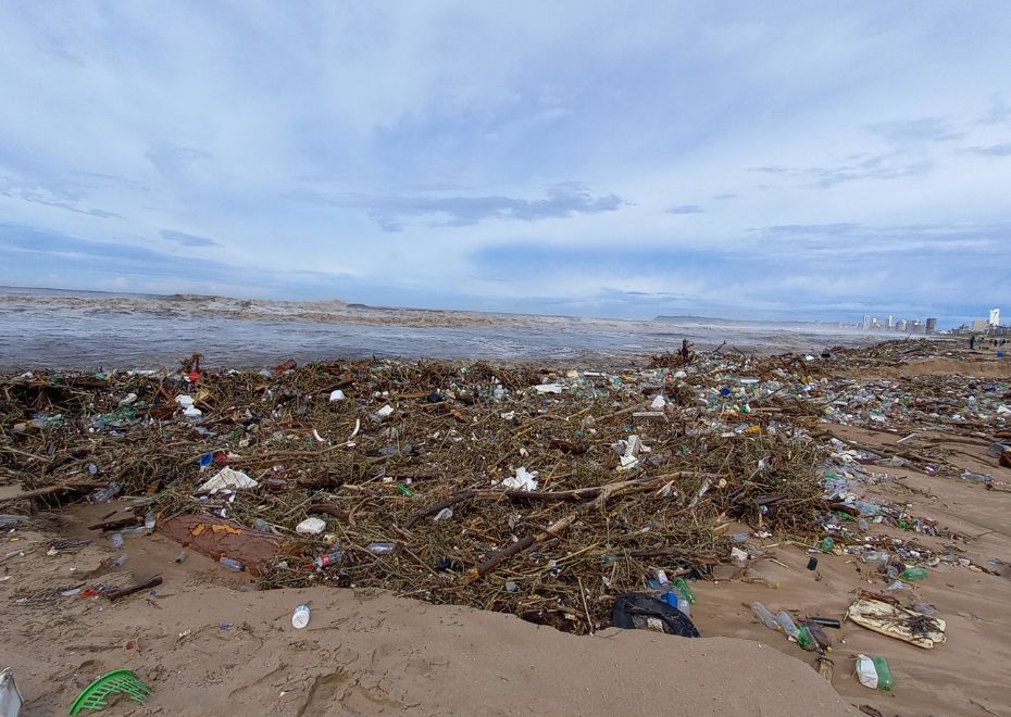 Photo of the coast of Durban after the floods, lots of debris and blue sky