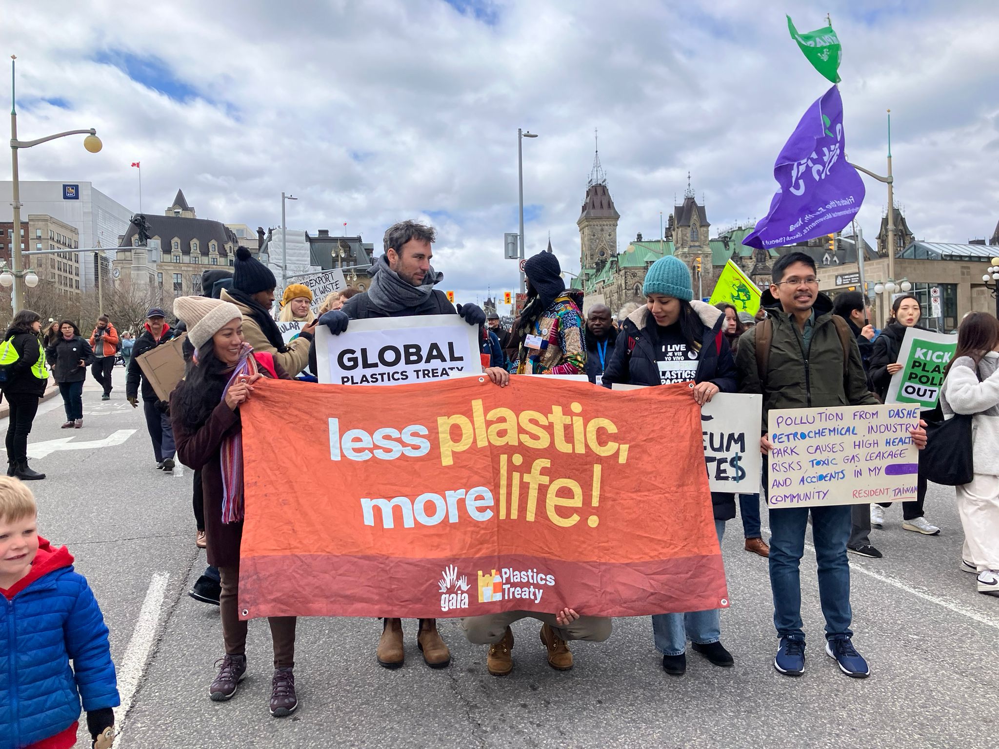 GAIA members join the March to End the Plastic Era in Ottawa, they are holding a streamer that says less plastic, more life.